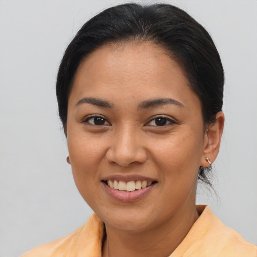 Joyful asian young-adult female with medium  brown hair and brown eyes