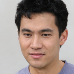 Joyful asian young-adult male with short  black hair and brown eyes