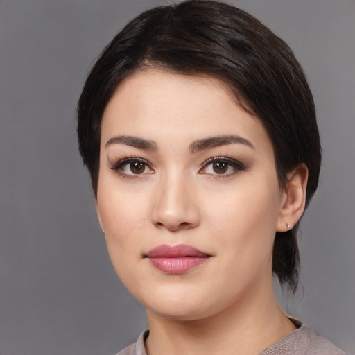 Joyful white young-adult female with medium  black hair and brown eyes