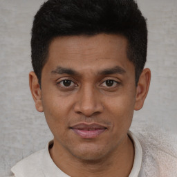 Joyful latino young-adult male with short  brown hair and brown eyes