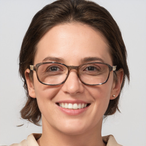 Joyful white adult female with medium  brown hair and blue eyes