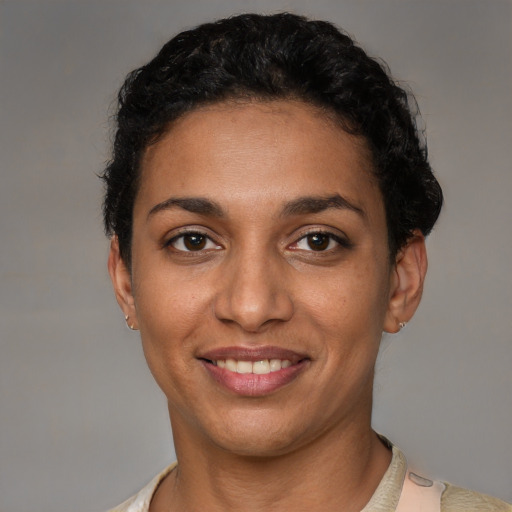 Joyful latino young-adult female with short  brown hair and brown eyes