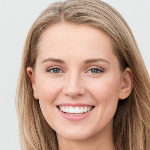 Joyful white young-adult female with long  brown hair and grey eyes