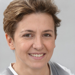 Joyful white adult female with short  brown hair and brown eyes