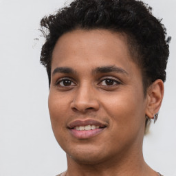 Joyful latino young-adult male with short  brown hair and brown eyes