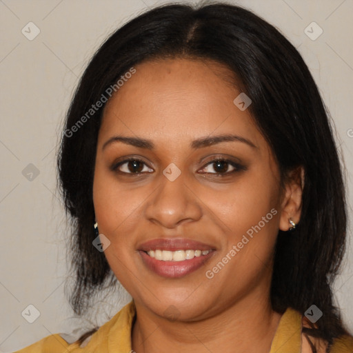 Joyful black young-adult female with long  brown hair and brown eyes