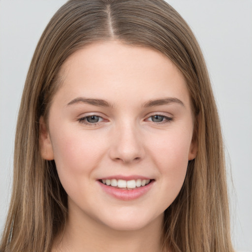 Joyful white young-adult female with long  brown hair and grey eyes