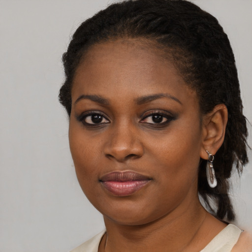 Joyful black young-adult female with medium  brown hair and brown eyes
