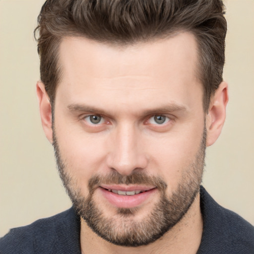 Joyful white young-adult male with short  brown hair and brown eyes