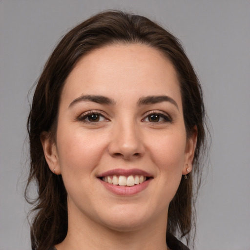 Joyful white young-adult female with medium  brown hair and brown eyes