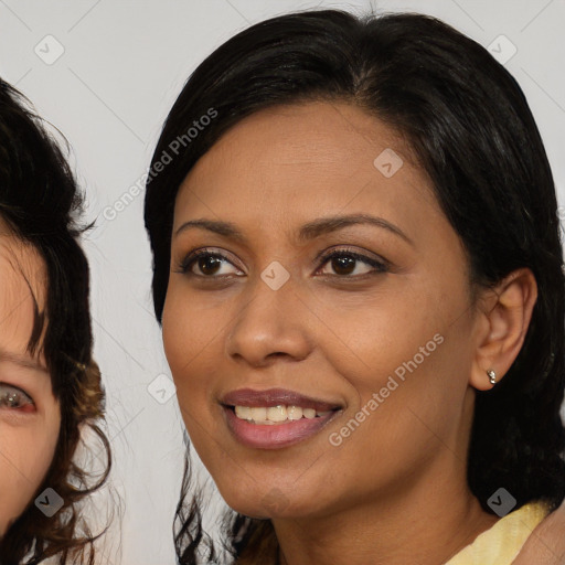 Joyful black adult female with medium  brown hair and brown eyes