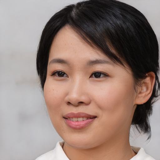 Joyful asian young-adult female with medium  black hair and brown eyes