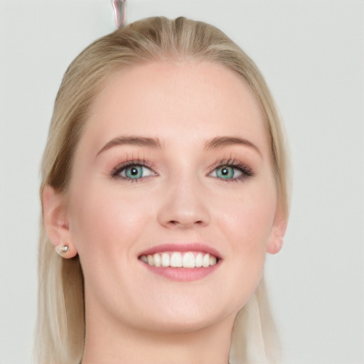 Joyful white young-adult female with long  brown hair and blue eyes