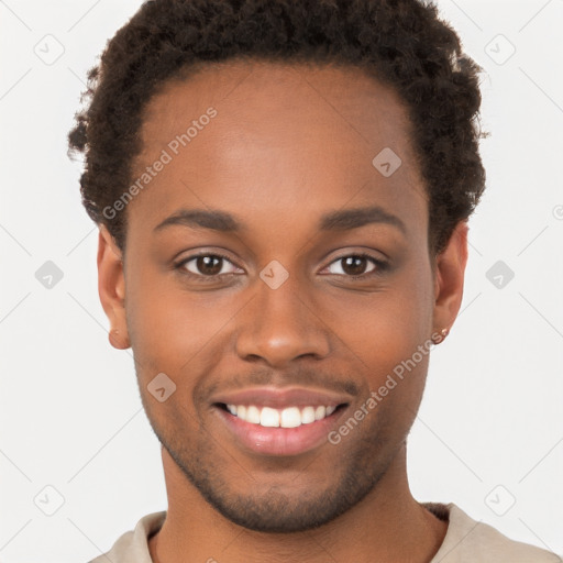 Joyful black young-adult male with short  brown hair and brown eyes