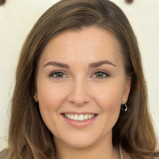 Joyful white young-adult female with long  brown hair and brown eyes