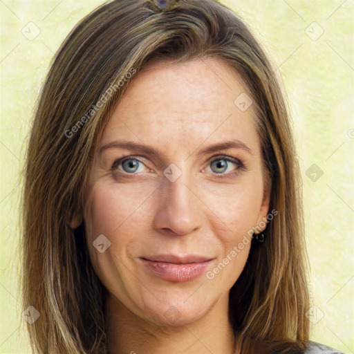 Joyful white adult female with long  brown hair and green eyes