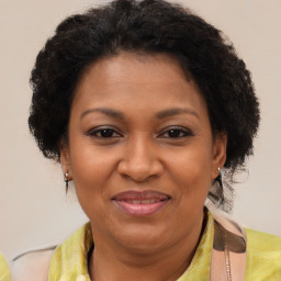 Joyful black adult female with medium  brown hair and brown eyes