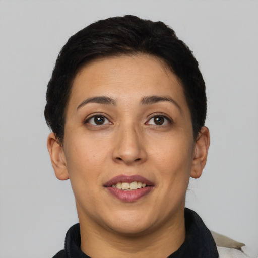 Joyful latino young-adult female with short  brown hair and brown eyes