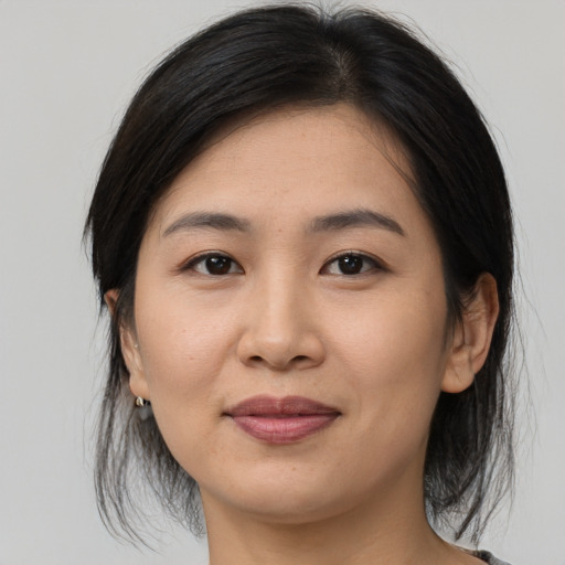 Joyful asian young-adult female with medium  brown hair and brown eyes
