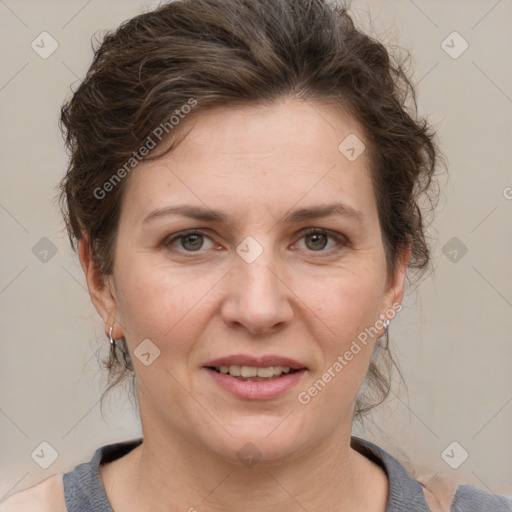 Joyful white adult female with short  brown hair and grey eyes