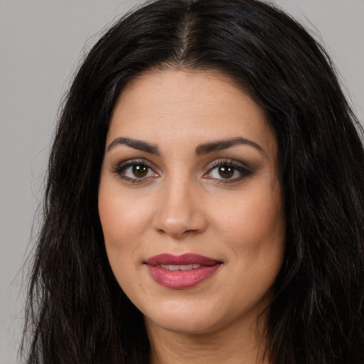 Joyful latino young-adult female with long  black hair and brown eyes