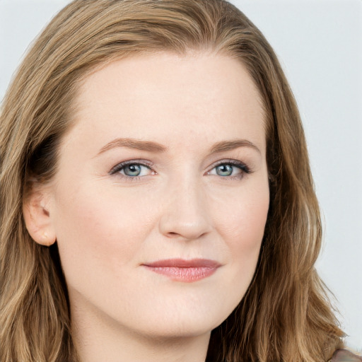 Joyful white young-adult female with long  brown hair and blue eyes