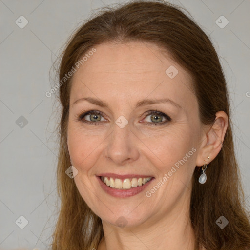 Joyful white adult female with long  brown hair and brown eyes