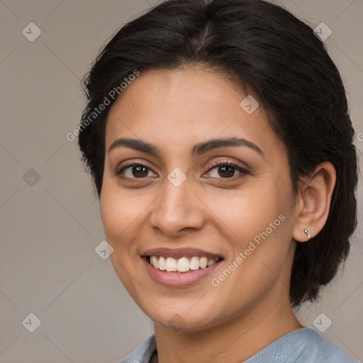 Joyful latino young-adult female with medium  brown hair and brown eyes