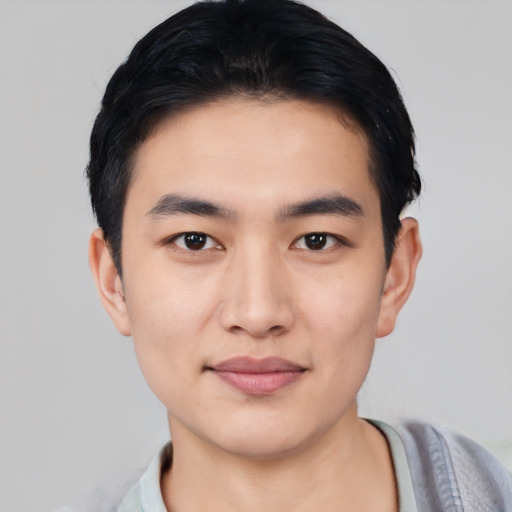 Joyful asian young-adult male with short  black hair and brown eyes