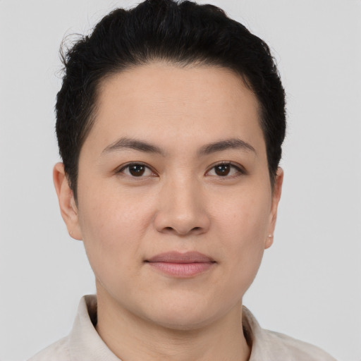 Joyful asian young-adult female with short  brown hair and brown eyes
