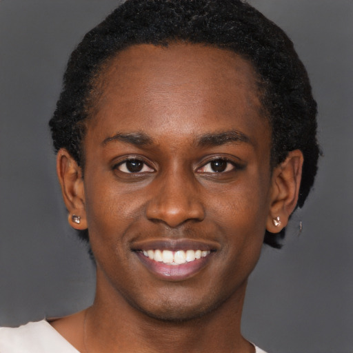 Joyful black young-adult male with short  brown hair and brown eyes