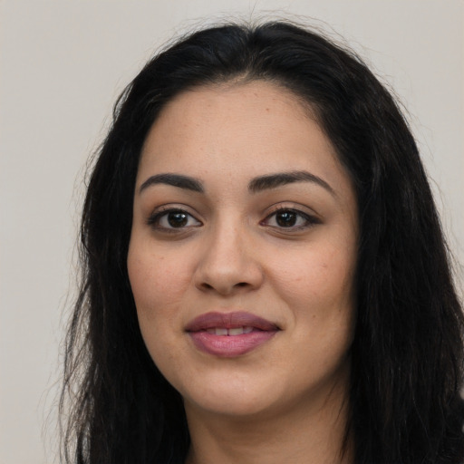 Joyful latino young-adult female with long  black hair and brown eyes