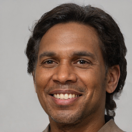 Joyful latino adult male with short  brown hair and brown eyes
