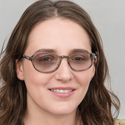 Joyful white young-adult female with long  brown hair and blue eyes