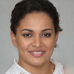 Joyful latino young-adult female with short  brown hair and brown eyes