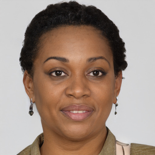 Joyful black adult female with short  brown hair and brown eyes