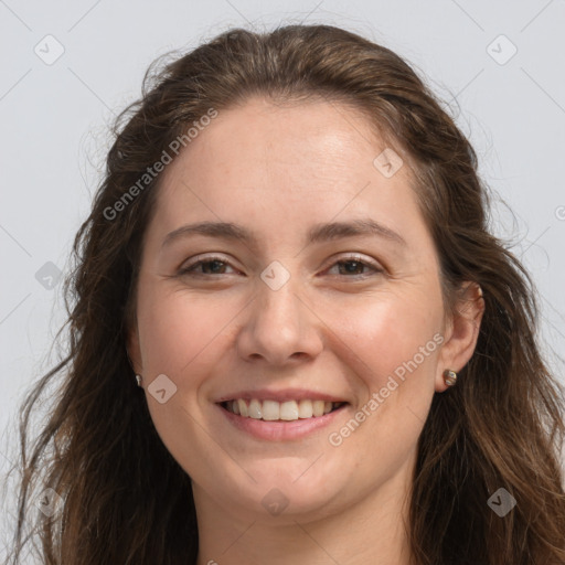 Joyful white adult female with long  brown hair and grey eyes