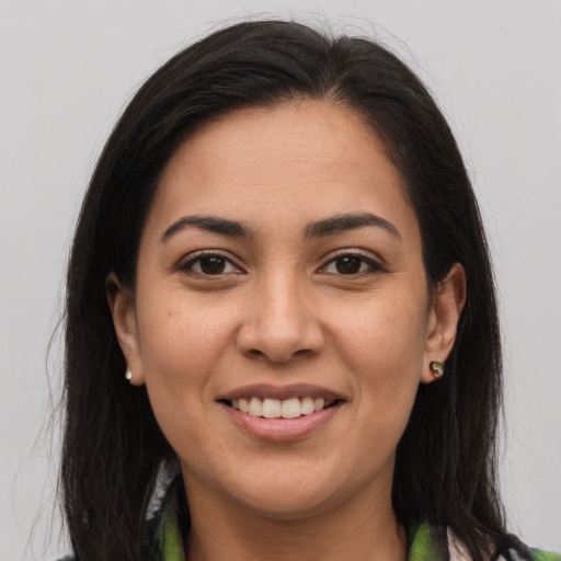 Joyful latino young-adult female with medium  brown hair and brown eyes