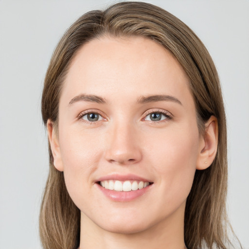 Joyful white young-adult female with long  brown hair and grey eyes