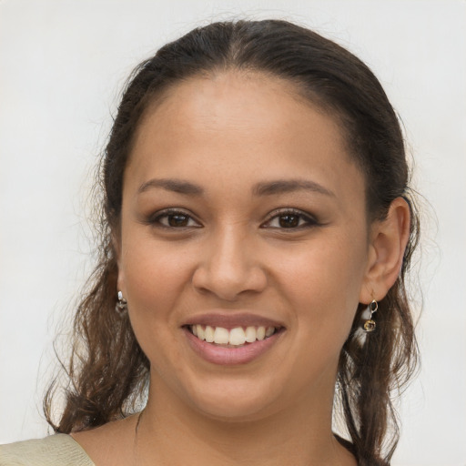 Joyful latino young-adult female with long  brown hair and brown eyes