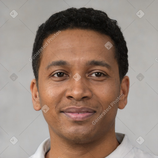 Joyful latino young-adult male with short  brown hair and brown eyes