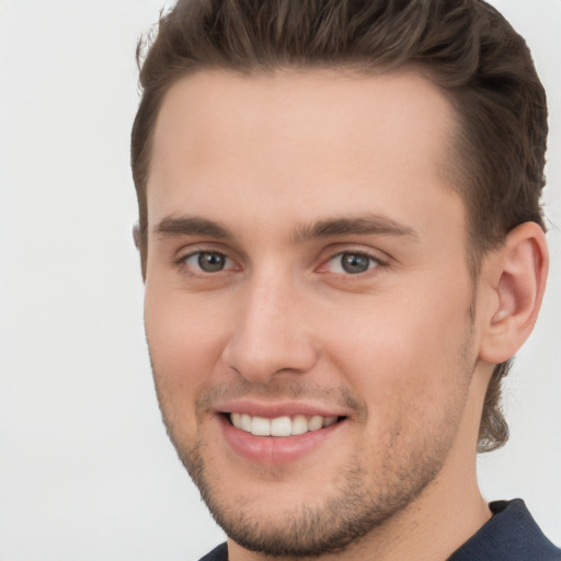 Joyful white young-adult male with short  brown hair and brown eyes