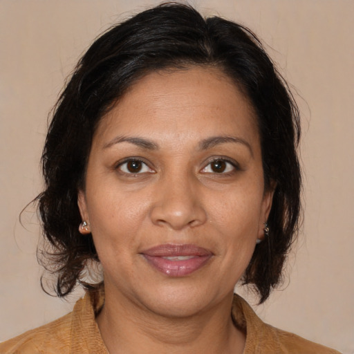 Joyful black adult female with medium  brown hair and brown eyes