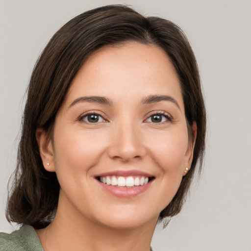 Joyful white young-adult female with medium  brown hair and brown eyes