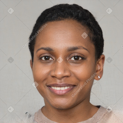 Joyful black young-adult female with short  black hair and brown eyes