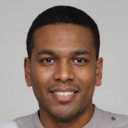 Joyful latino young-adult male with short  brown hair and brown eyes