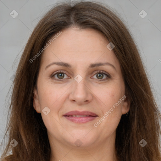 Joyful white adult female with long  brown hair and brown eyes