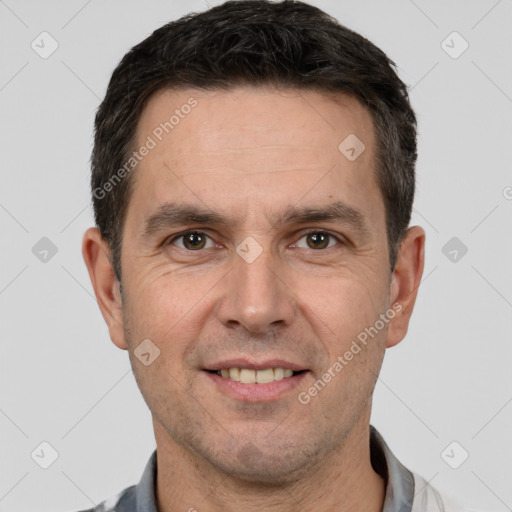 Joyful white adult male with short  brown hair and brown eyes