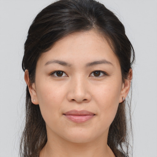 Joyful asian young-adult female with medium  brown hair and brown eyes