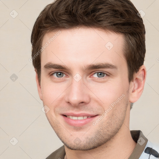 Joyful white young-adult male with short  brown hair and grey eyes